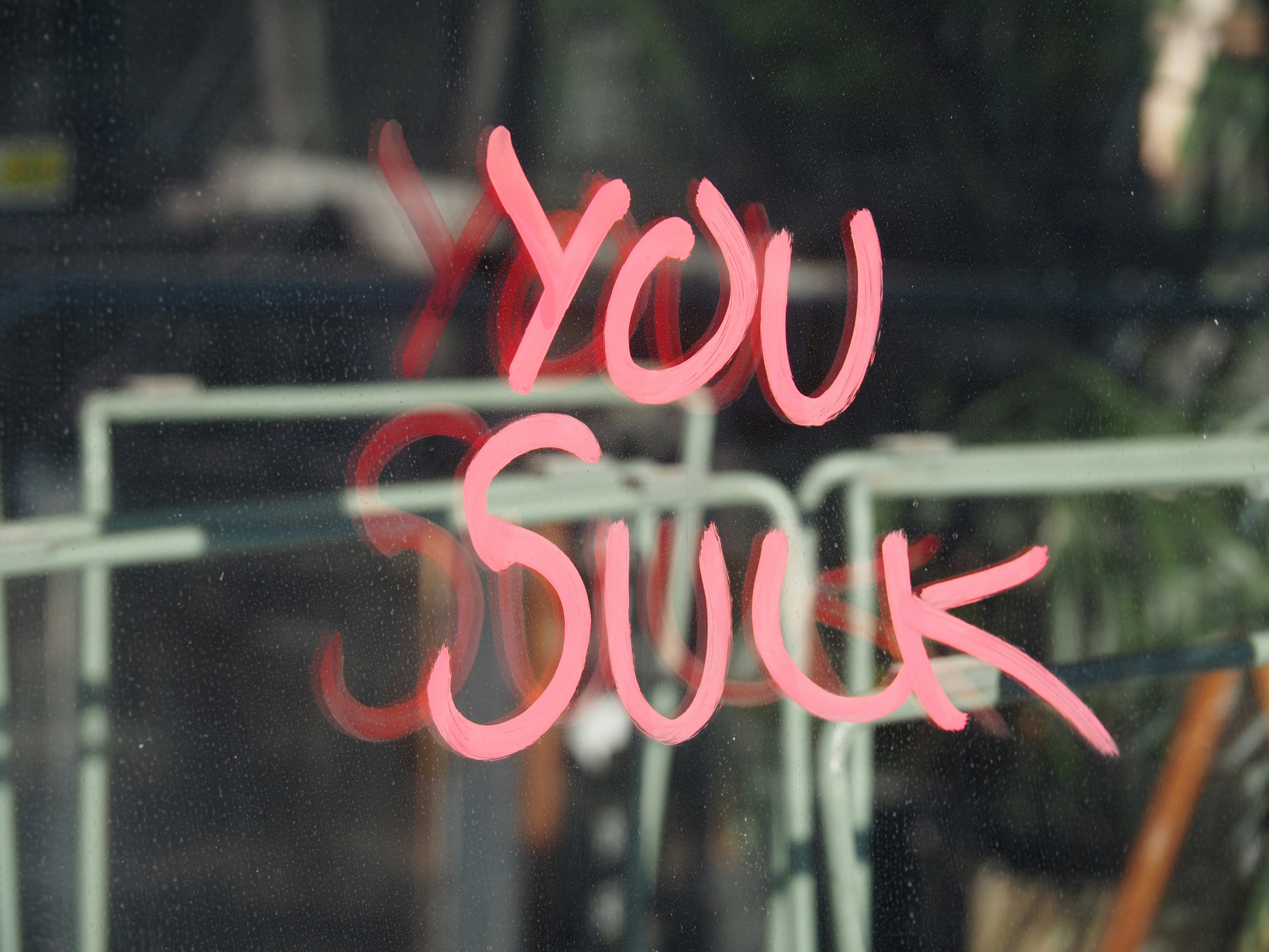 You suck sign on shop